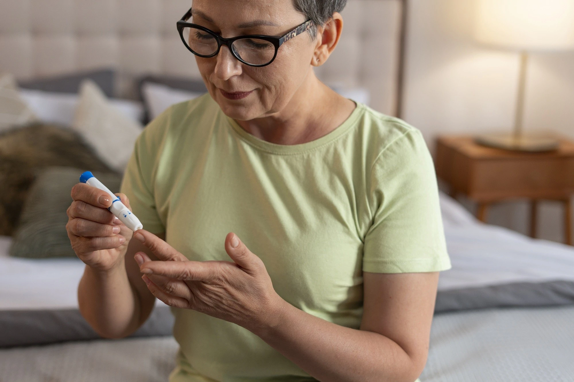 Patient checking glucose levels while preparing for a diabetes education consult.